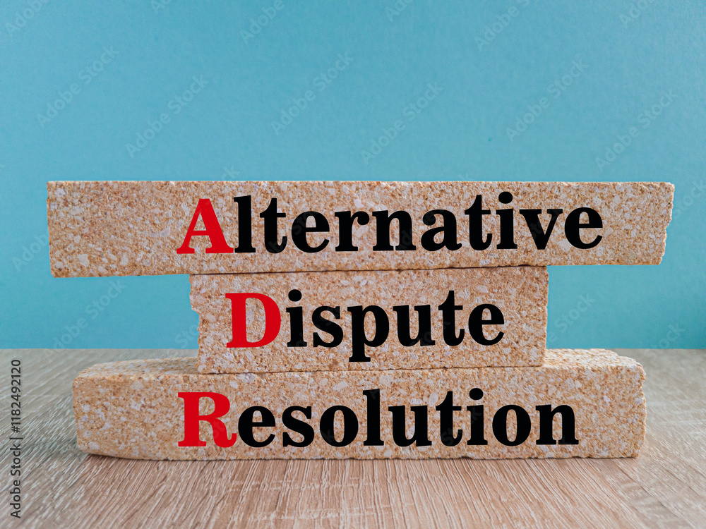 Concept words Alternative Dispute Resolution on brick blocks. Beautiful blue background, wooden table. Business concept.