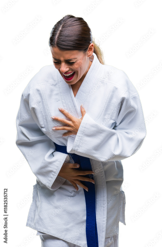 Young beautiful woman wearing karate kimono uniform over isolated background with hand on stomach because nausea, painful disease feeling unwell. Ache concept.