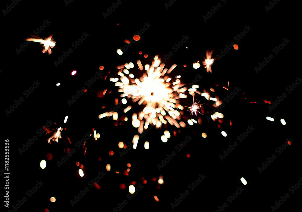 Obraz premium Festive sparks from a sparkler on a black background