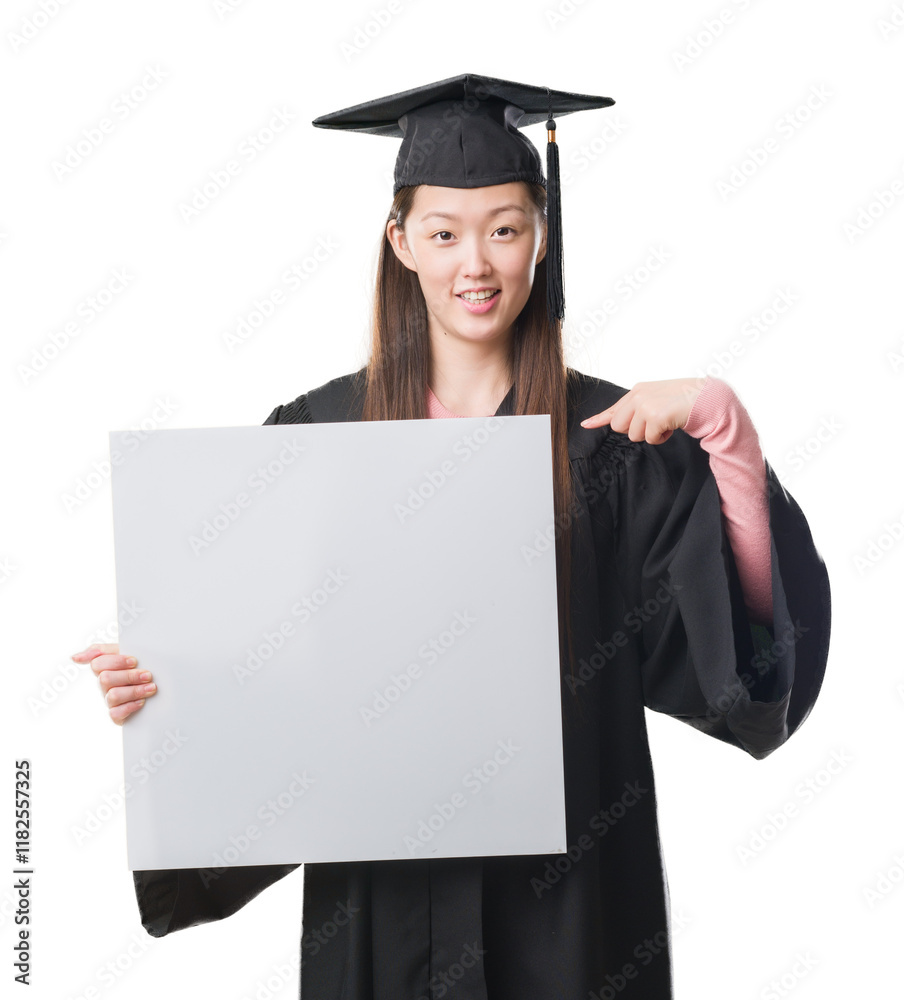 Young Chinese woman wearing graduate uniform holding banner with surprise face pointing finger to himself Young Chinese woman wearing graduate uniform holding banner with surprise face pointing finger to himself