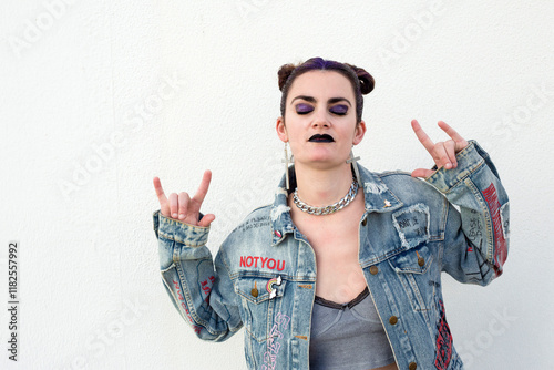 Young punk woman with purple hair and graffiti denim jacket