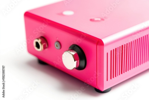 A pink radio sits on a white surface, waiting for use photo