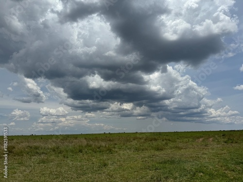 dark clouds forming above the serengeti national park, rain season photo