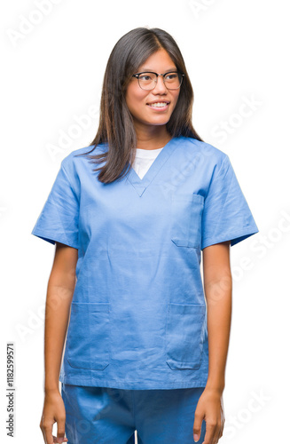 Young asian doctor woman over isolated background looking away to side with smile on face, natural expression. Laughing confident.