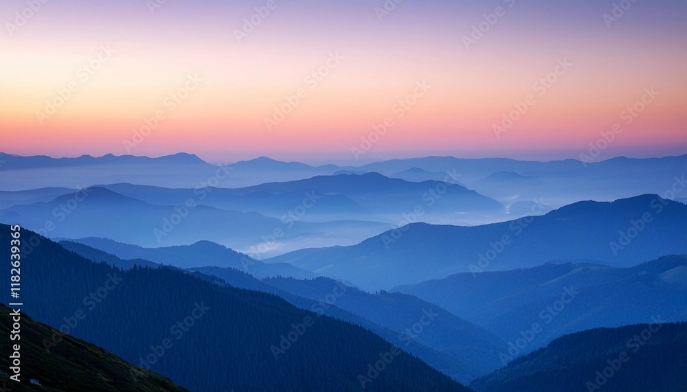 Obraz premium a serene landscape of layered blue mountains under a pastel colored sky at dusk showcasing the beauty of nature s tranquility