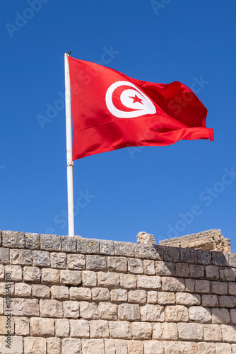 Dougga, Beja, Tunisia. Tunisian flag flying at the Roman ruins. photo