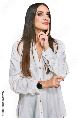 Young beautiful woman wearing casual white shirt with hand on chin thinking about question, pensive expression. smiling and thoughtful face. doubt concept.