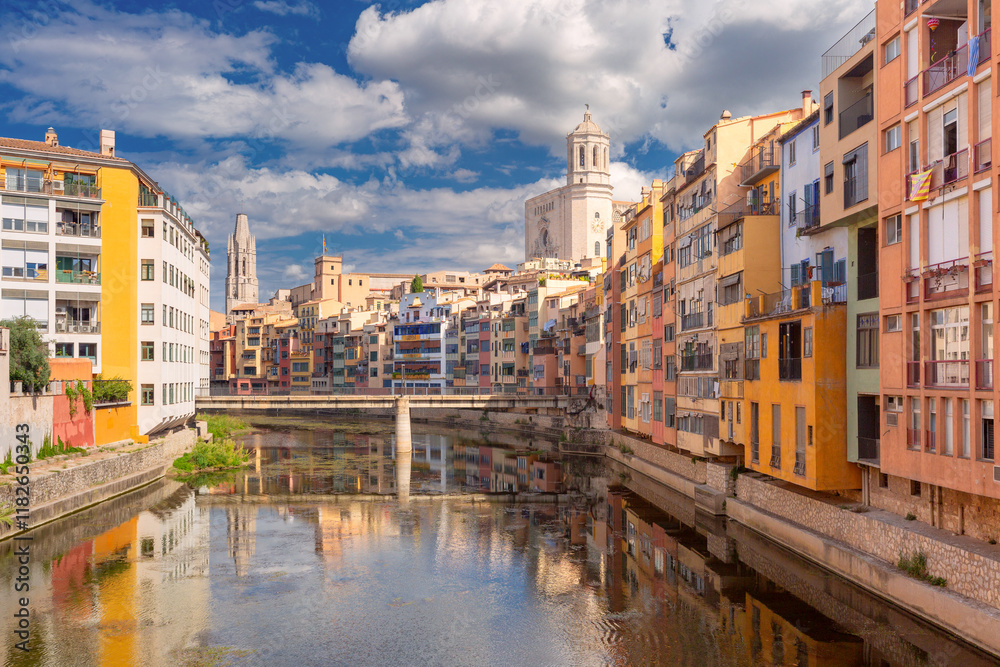 View of Girona Cathedral and colorful buildings along the Onyar River in Girona, Spain View of Girona Cathedral and colorful buildings along the Onyar River in Girona, Spain