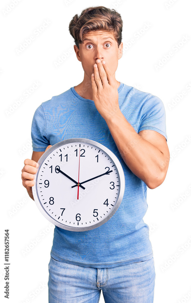 Young handsome man holding big clock covering mouth with hand, shocked and afraid for mistake. surprised expression Young handsome man holding big clock covering mouth with hand, shocked and afraid for mistake. surprised expression