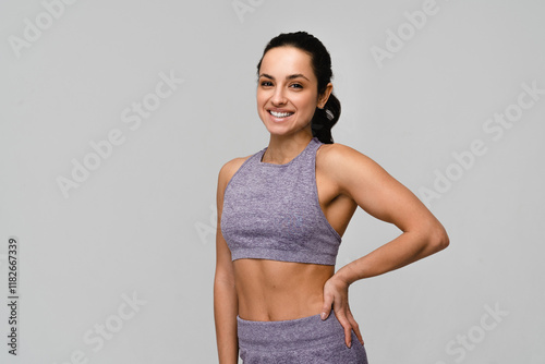 Foto Young strong sporty woman athletic fitness trainer instructor coach wear pastel tracksuit spend time in home gym hold hands on waist isolated on white background copy space