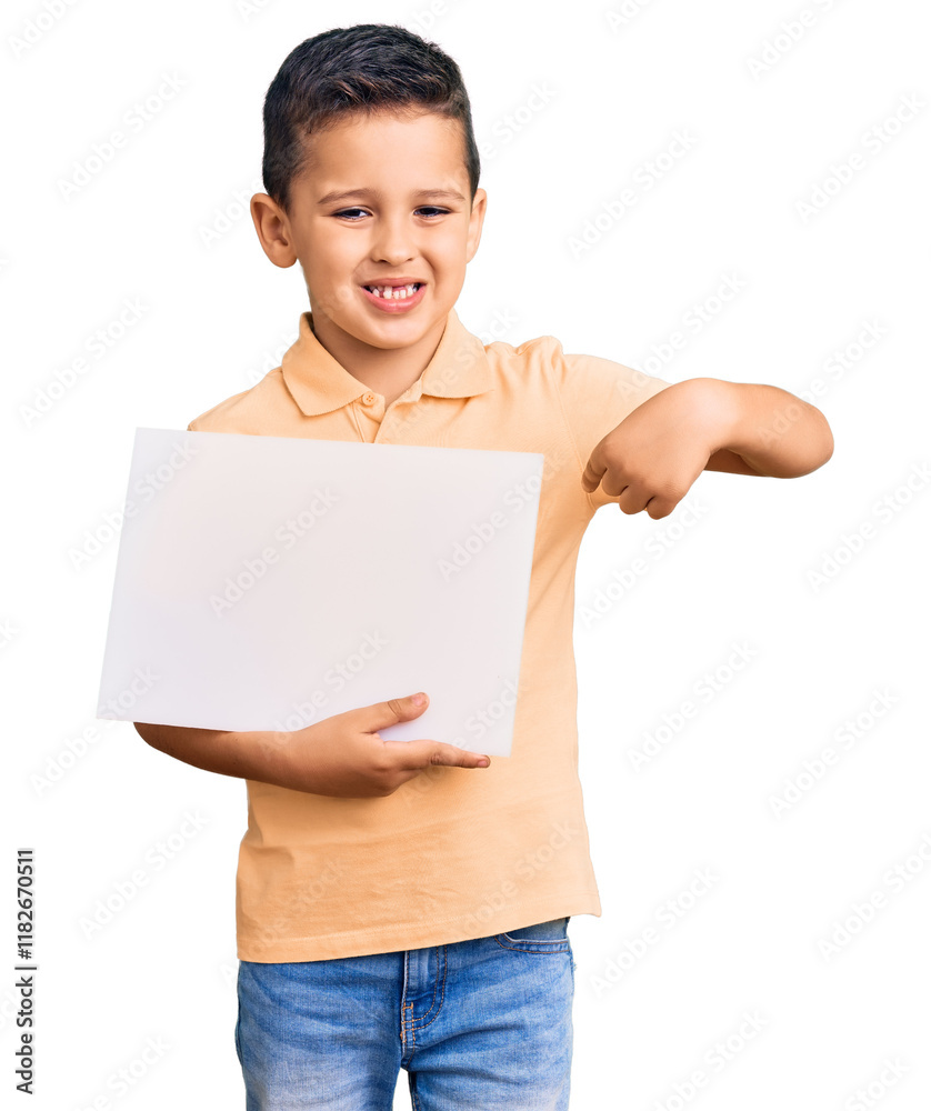 Little cute boy kid holding cardboard banner with blank space pointing finger to one self smiling happy and proud Little cute boy kid holding cardboard banner with blank space pointing finger to one self smiling happy and proud