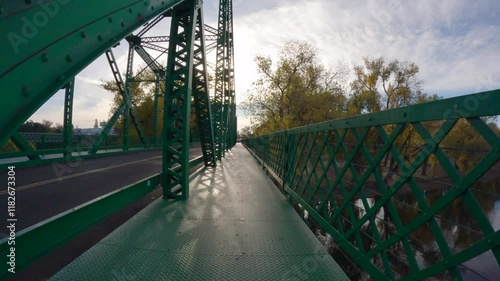 Riding over the historic metal Jibboom Street Bridge on the American River Bike Trail in Sacramento California.  