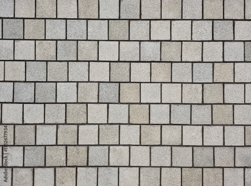 Background of multi grey square granite tile wall. Rough surface textured granite square tile wall for decoration. Background of multi grey square granite tile wall. Rough surface textured granite square tile wall for decoration.