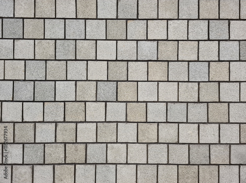 Background of multi grey square granite tile wall. Rough surface textured granite square tile wall for decoration.