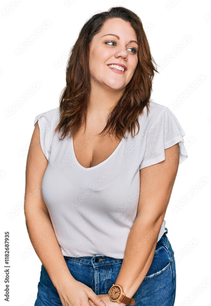 Young plus size woman wearing casual white t shirt looking away to side with smile on face, natural expression. laughing confident. Young plus size woman wearing casual white t shirt looking away to side with smile on face, natural expression. laughing confident.