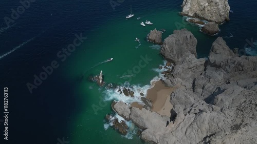 Vista aérea de Baja California, Los Cabos, Toma en drone  capturada con drone en un día soleado, mostrando un paisaje desértico con colinas y formaciones rocosas bajo un cielo azul despejado.  photo