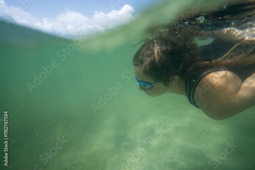 A person Swimming Underwater in Clear Ocean
 photo