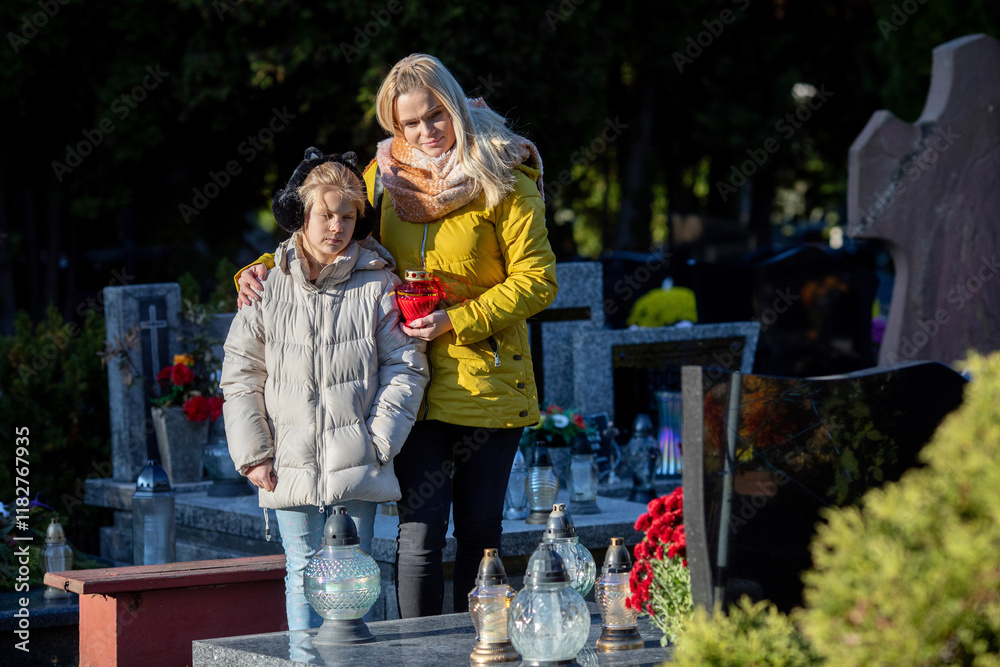 A Mother and her Son are Visiting the Cemetery Together During Remembrance Day to Honor Loved Ones A Mother and her Son are Visiting the Cemetery Together During Remembrance Day to Honor Loved Ones