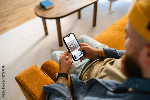 A man uses a mobile phone at home