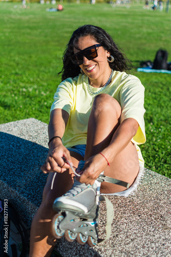 Woman tying her skates laces in a sunny day