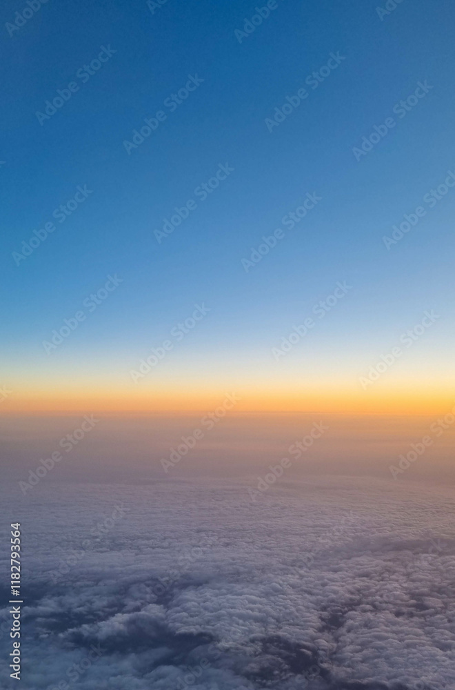 Beautiful sunset sky above clouds with dramatic light. Cabin view from airplane Beautiful sunset sky above clouds with dramatic light. Cabin view from airplane
