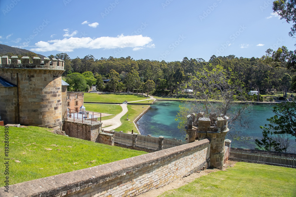 Obraz premium Port Arthur historical site in Tasmania, Australia, with stone tower, scenic waterfront, and lush green surroundings