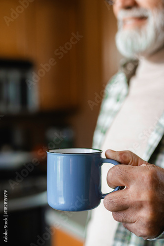A man holds a mug in his hand
