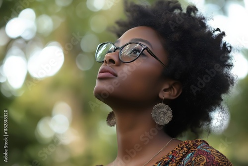 A contemplative woman looks up, showcasing her stunning features. photo