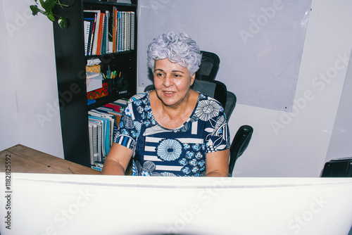 Elderly woman working on computer  photo