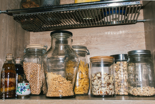 Kitchen shelf with jars of spices and grains
