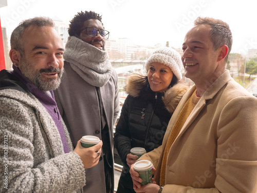 Four office workers on a coffee break in a business district. One looks at the camera with a confident expression, as if knowing something the others don t.