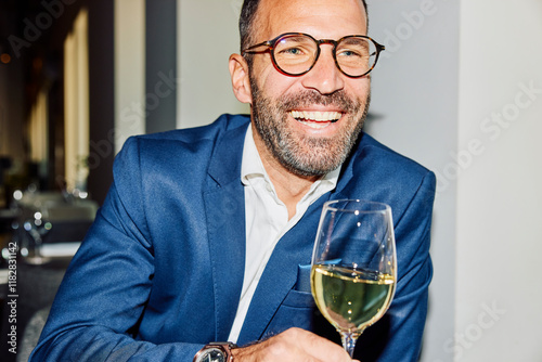 Happy man drinks wine at a restaurant photo