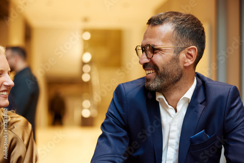 Portrait of a handsome man talking to his colleague photo