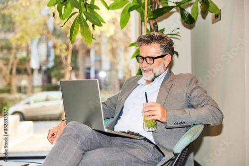 Businessman enjoys video call via laptop photo