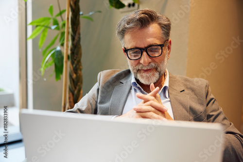 Businessman attends metting via laptop photo