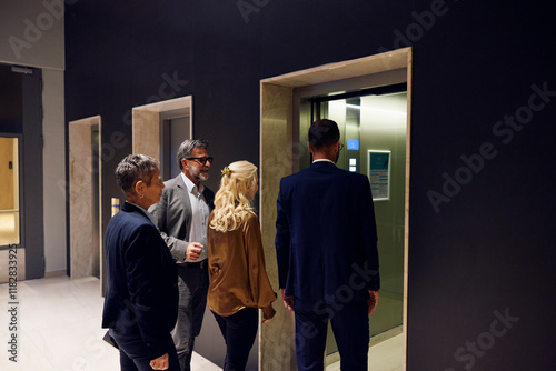 Businesspeople enter the elevator photo