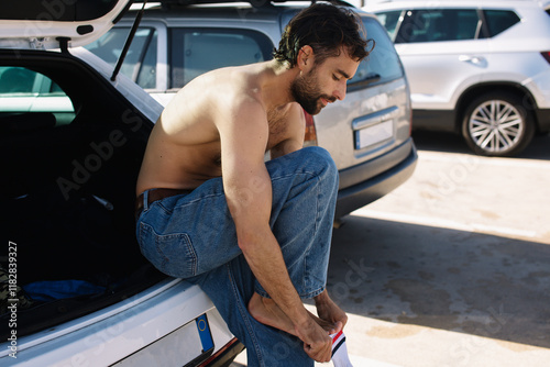 A young surfer changing clothes  photo