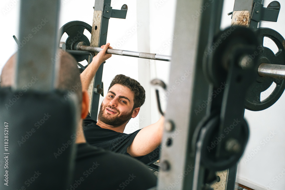 © Laura Herrera/Stocksy - Man lifting weights in a gym © Laura Herrera/Stocksy - Man lifting weights in a gym