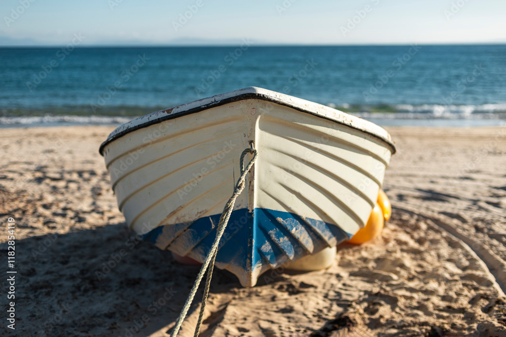 Tied fishing boat on sandy beach Tied fishing boat on sandy beach
