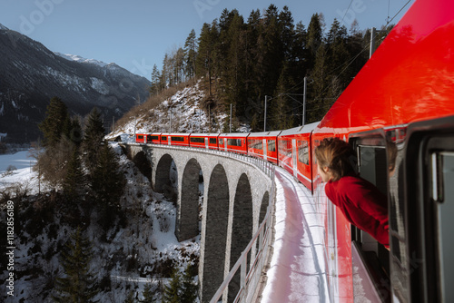 Woman traveling on Bernina express. Landwasser viaduct photo