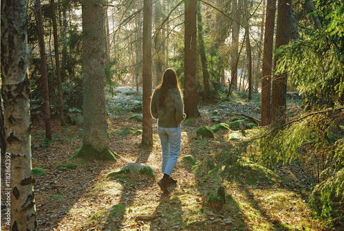 A young woman roaming through the forest