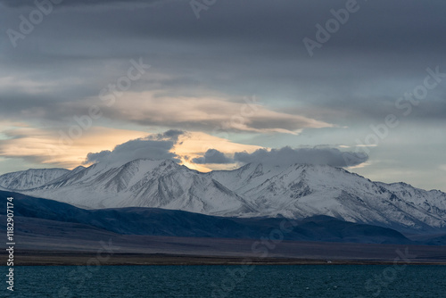 Asia, Mongolia, Bayan-Olgii Province, Altai Mountains, Lake Tolbo. Scenic view of the rugged, snow covered mountains rising above Lake Tolbo. photo