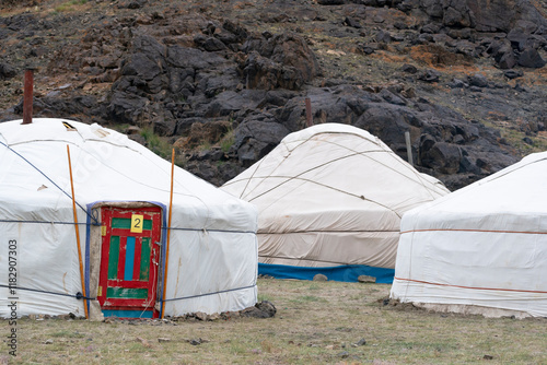 Asia, Mongolia, Bayan-Olgii Province. A group of gers are nestled near the rocky scree.