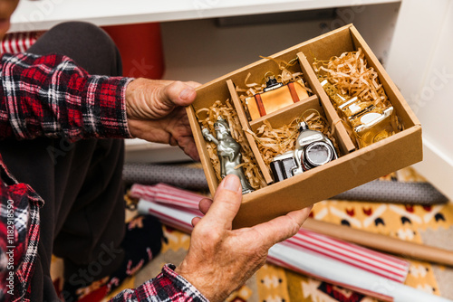 A man pulls out Christmas ornaments for the tree  photo