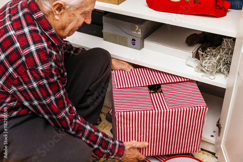 A man pulls out a box of Christmas decorations  photo