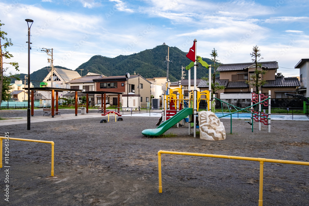 A local park with children's playground equipment including slides and climbing frames in Gifu, Japan. Out door play space in a Japanese neighbourhood. Community public leisure amenities for families. A local park with children's playground equipment including slides and climbing frames in Gifu, Japan. Out door play space in a Japanese neighbourhood. Community public leisure amenities for families.