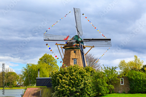 Netherlands, North Holland. Weesp. Typical Molen, windmills with Dutch flags. Molen Vriendschap, the Friendship windmills. photo