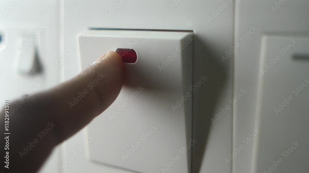 A finger turning on lighting switch .