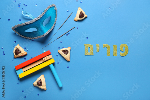 Composition with carnival mask, Hamantaschen cookies and rattle for Purim holiday on color background photo