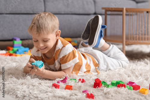 Happy cute little boy playi...